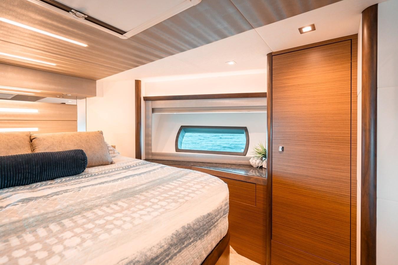 a room with a bed and a couch aboard THE THREE B'S Yacht for Sale