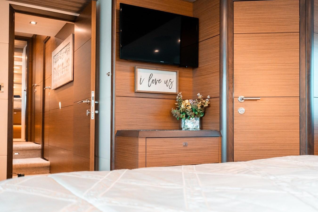 a bed with a television on the wall aboard THE THREE B'S Yacht for Sale