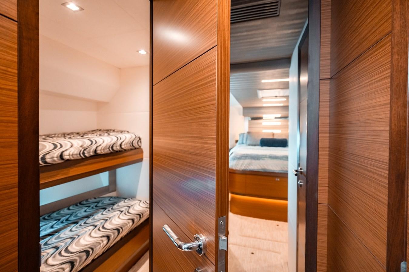 a room with a bed and a closet aboard THE THREE B'S Yacht for Sale