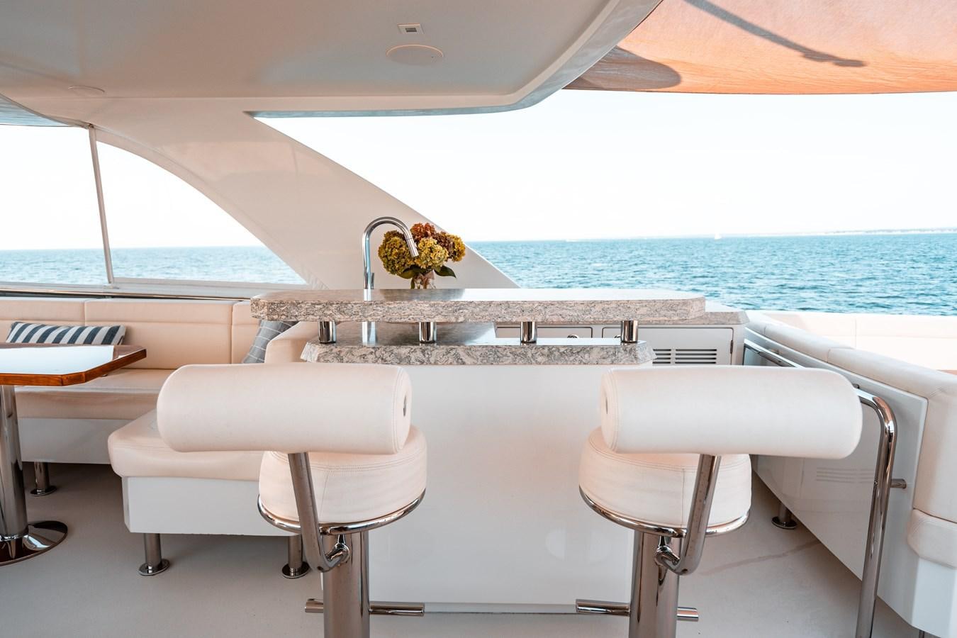 a white table with chairs and a sink on it aboard THE THREE B'S Yacht for Sale