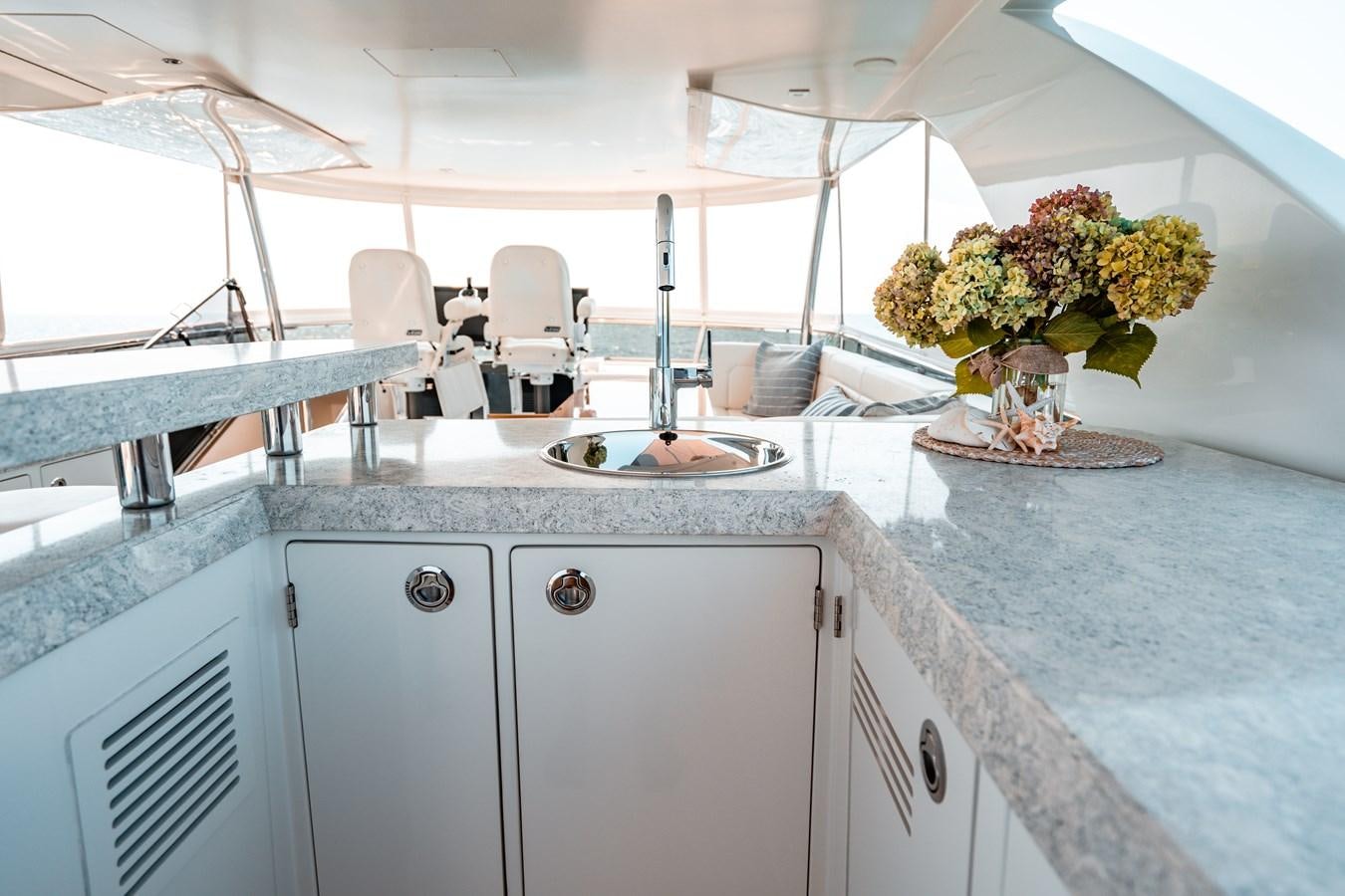 a kitchen with a sink and a plant on the counter aboard THE THREE B'S Yacht for Sale