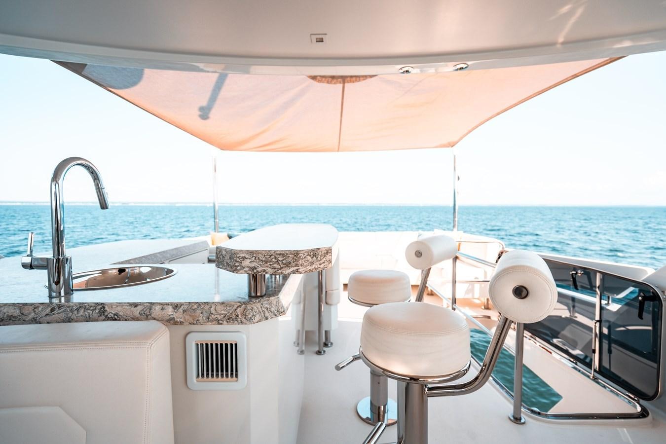 a large white tub with a sink and chairs on it aboard THE THREE B'S Yacht for Sale