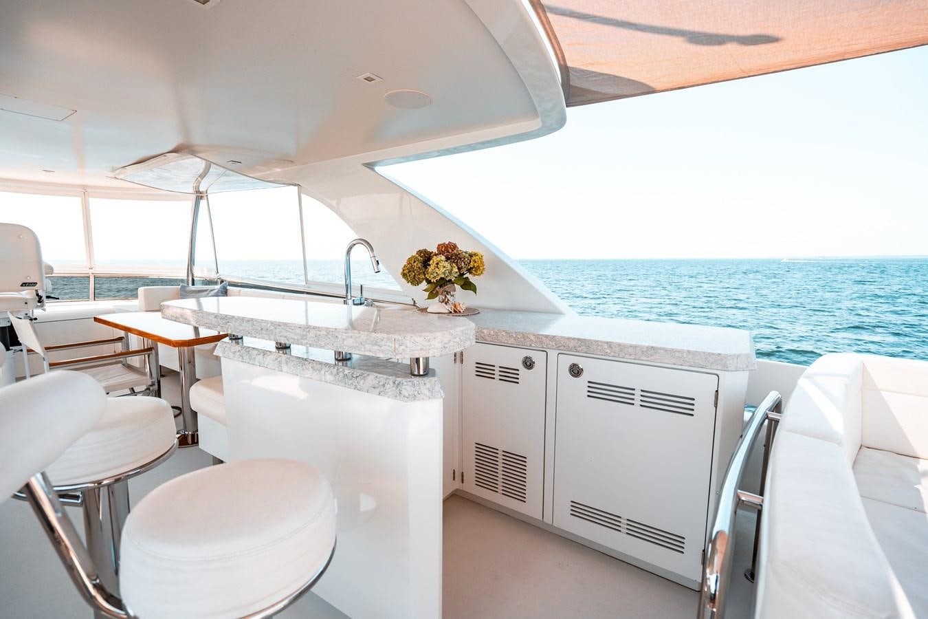 a white kitchen with a large window aboard THE THREE B'S Yacht for Sale