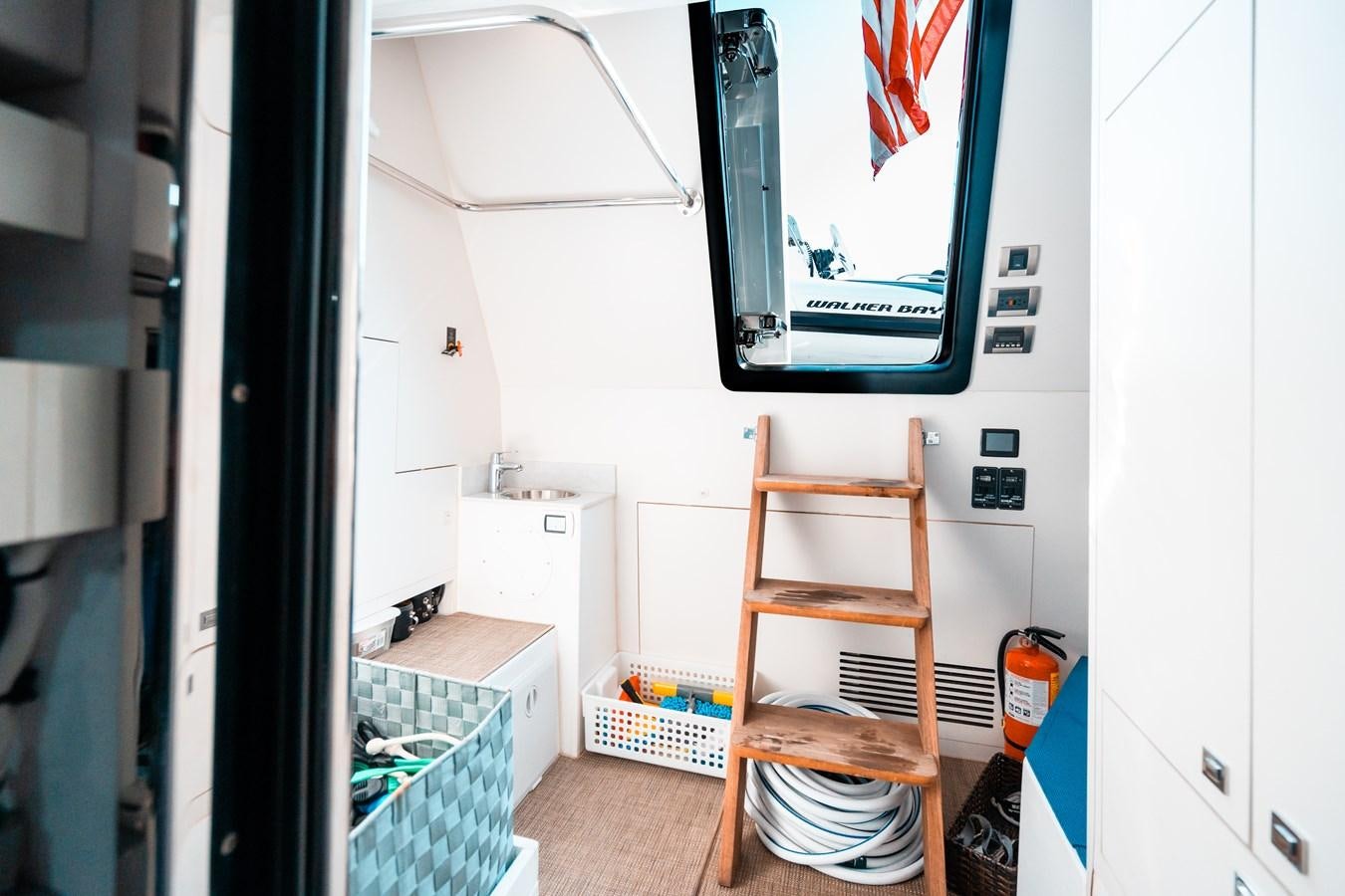 a room with a television and a shelf with objects on it aboard THE THREE B'S Yacht for Sale