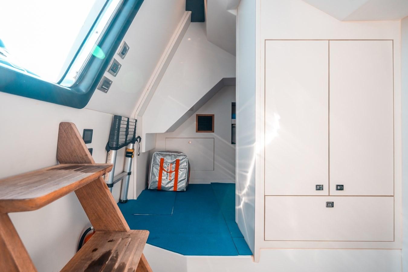 a room with a bed and a desk aboard THE THREE B'S Yacht for Sale