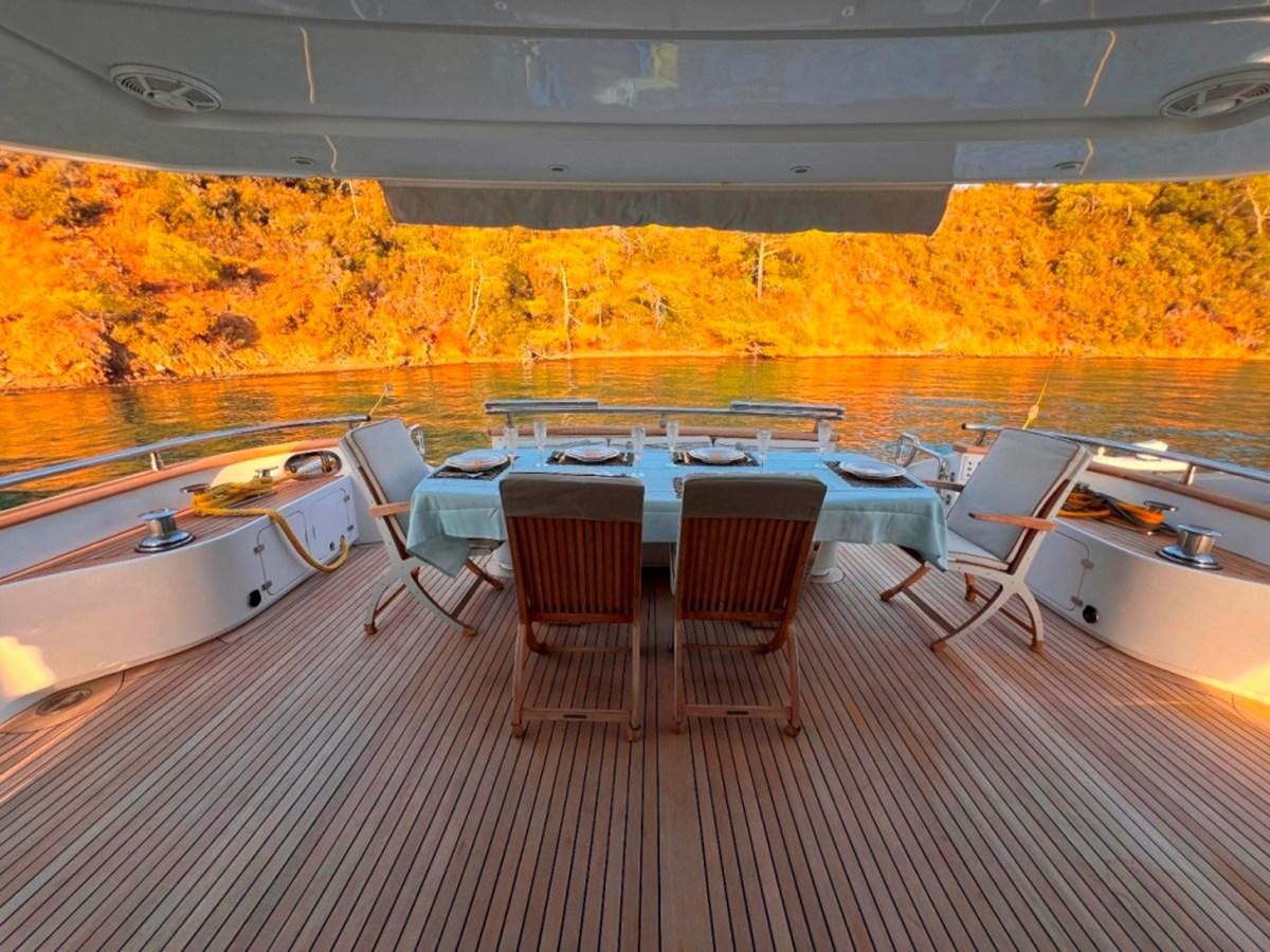 a room with a table and chairs aboard MAIORA 26 Yacht for Sale