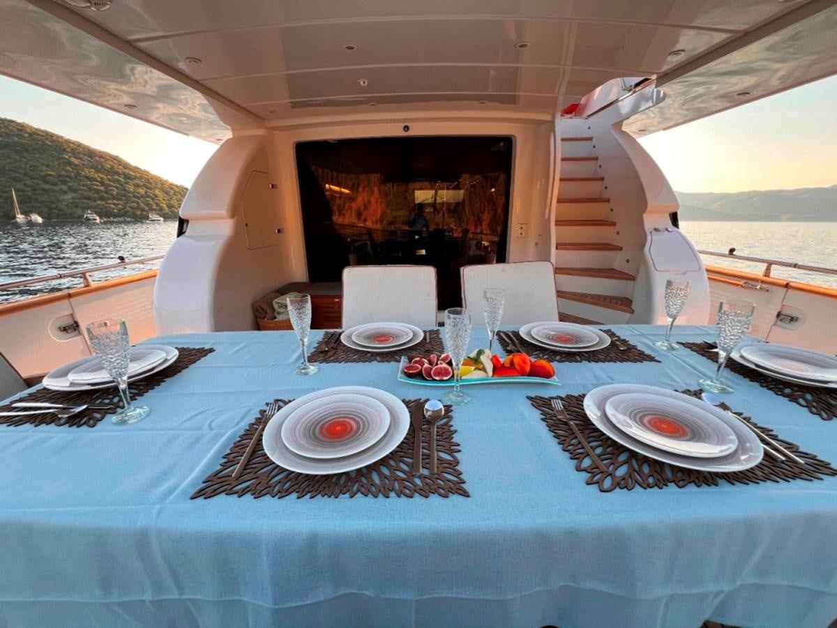 a table set for a dinner party aboard MAIORA 26 Yacht for Sale