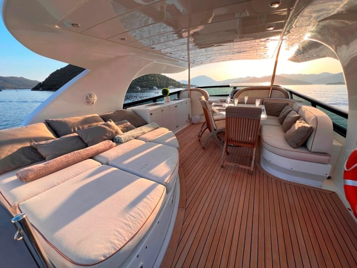a boat with a couch and chairs aboard MAIORA 26 Yacht for Sale