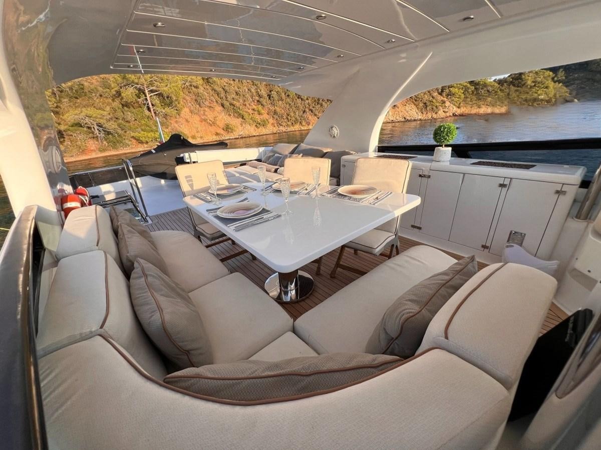 a room with a couch and a table with chairs aboard MAIORA 26 Yacht for Sale