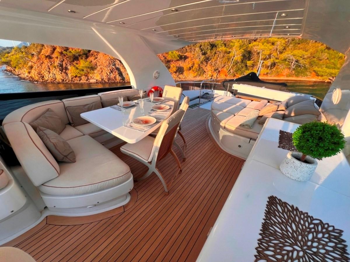 a restaurant with a large table and chairs aboard MAIORA 26 Yacht for Sale