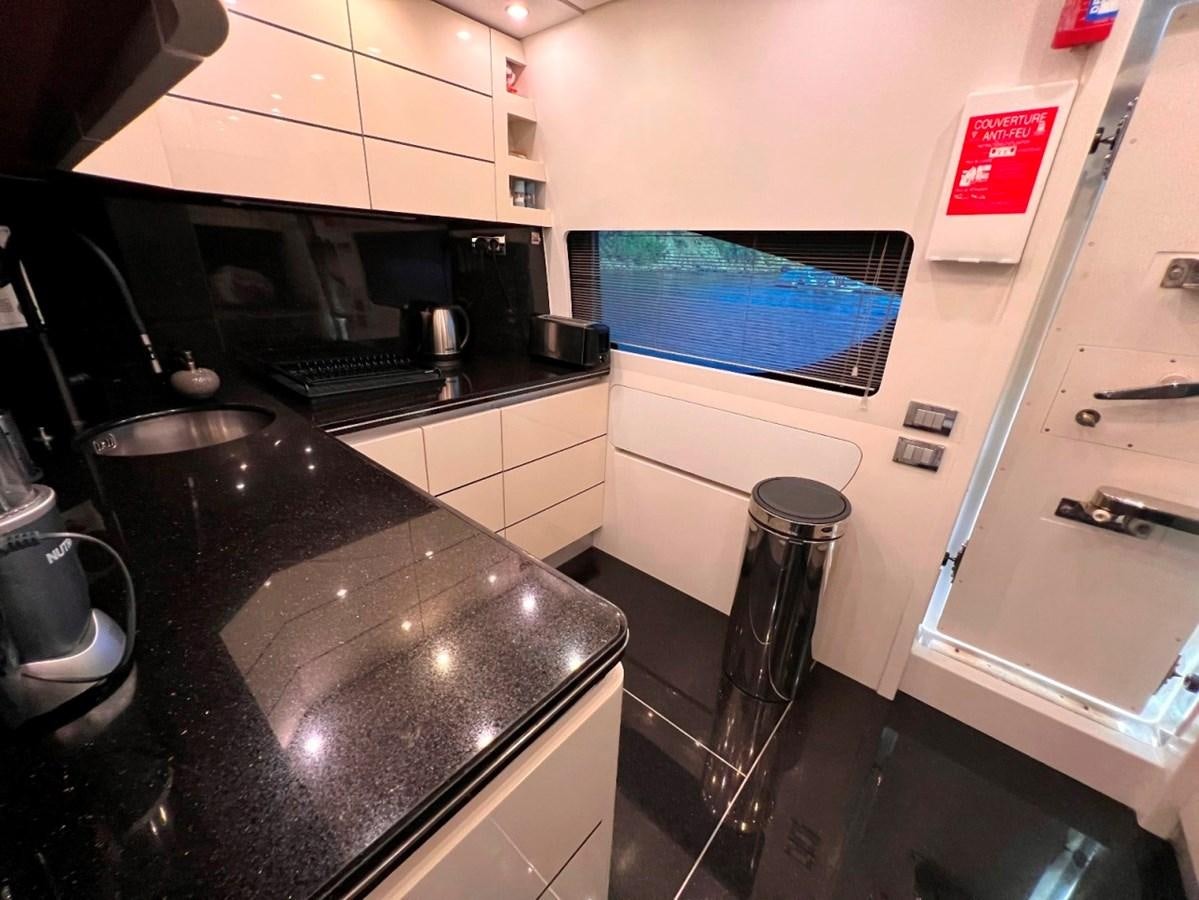 a kitchen with a black counter aboard MAIORA 26 Yacht for Sale