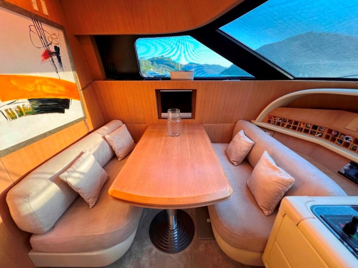 a room with a couch and a guitar aboard MAIORA 26 Yacht for Sale
