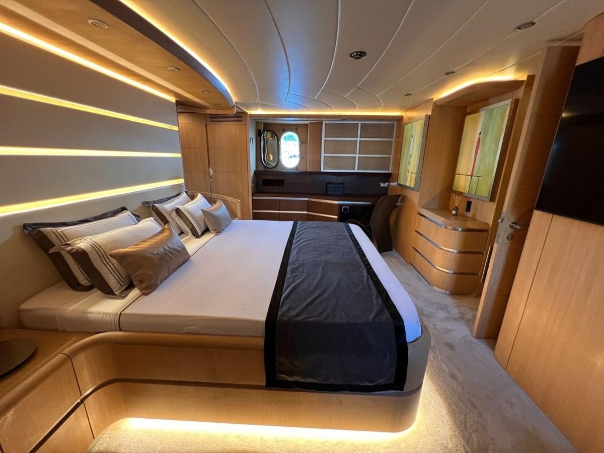 a room with a bed and a chair aboard MAIORA 26 Yacht for Sale