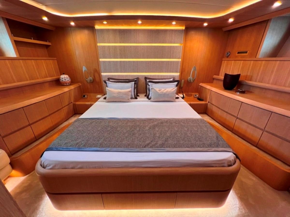 a bed with a blue cover aboard MAIORA 26 Yacht for Sale