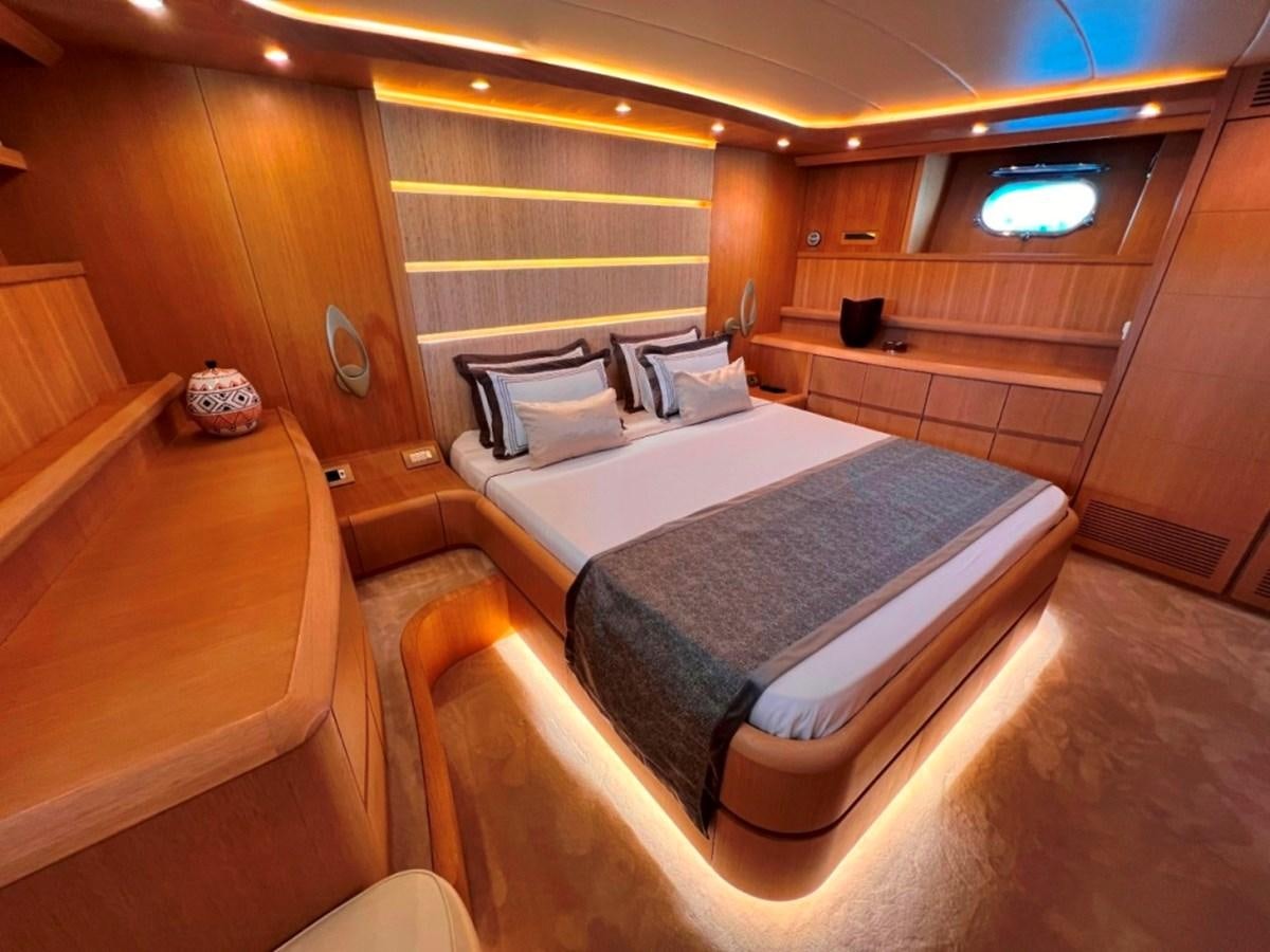 a room with a bed and a wood wall aboard MAIORA 26 Yacht for Sale