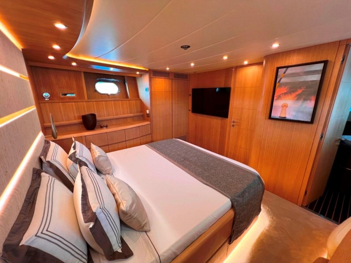 a room with a bed and a television aboard MAIORA 26 Yacht for Sale