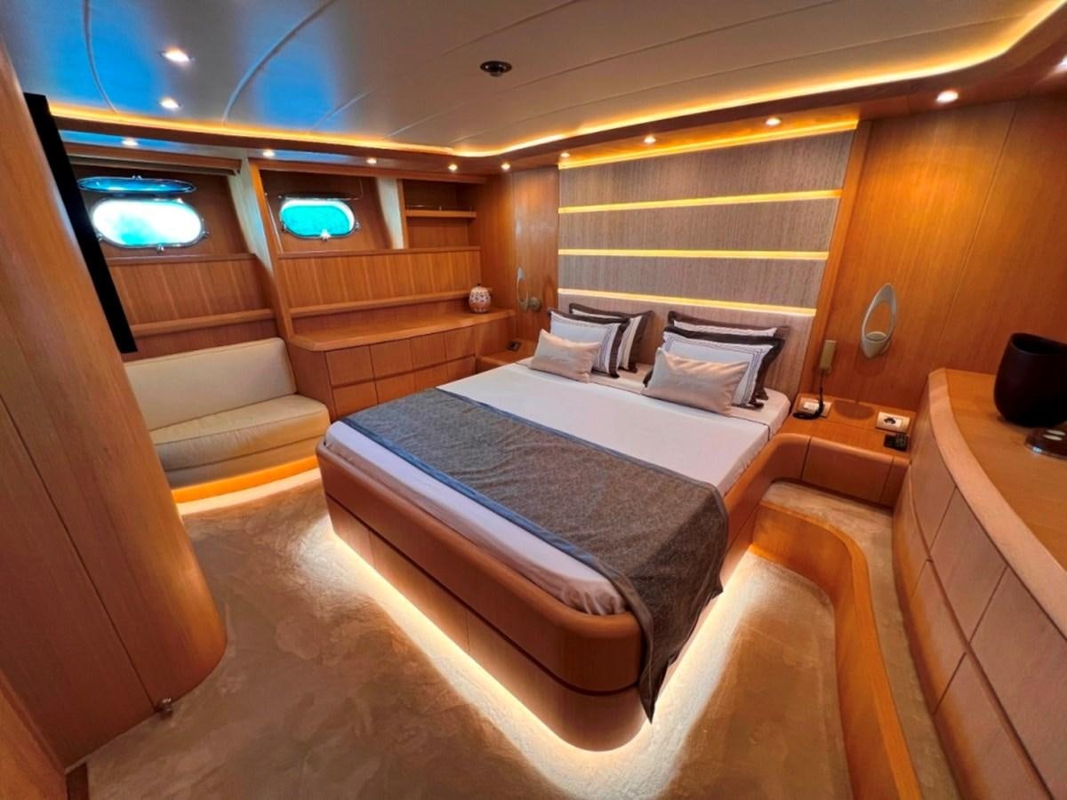 a room with a bed and a window aboard MAIORA 26 Yacht for Sale
