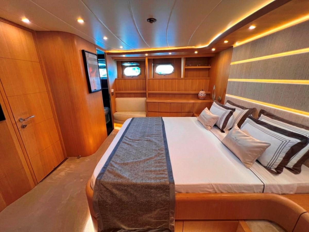 a room with a bed and a wood door aboard MAIORA 26 Yacht for Sale