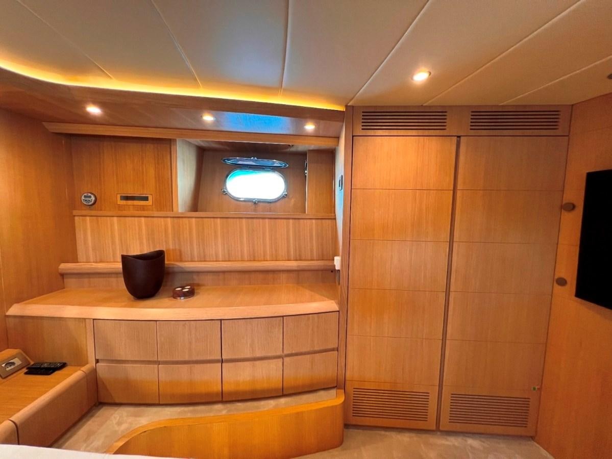 a room with a wood cabinet and a black cup on the counter aboard MAIORA 26 Yacht for Sale