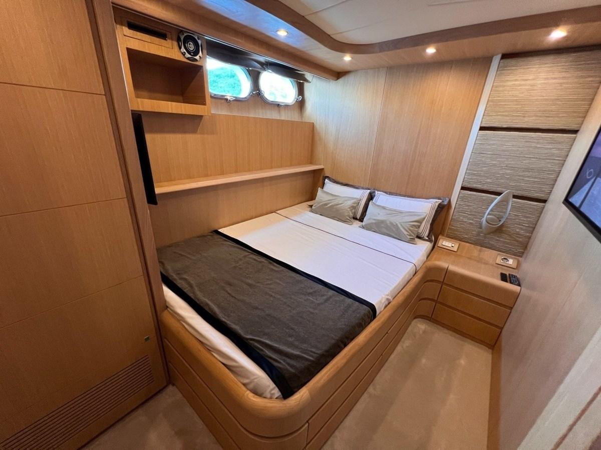 a room with a bed and a window aboard MAIORA 26 Yacht for Sale