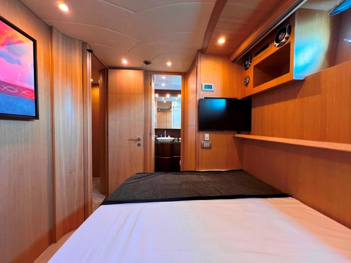 a room with a bed and a tv on the wall aboard MAIORA 26 Yacht for Sale