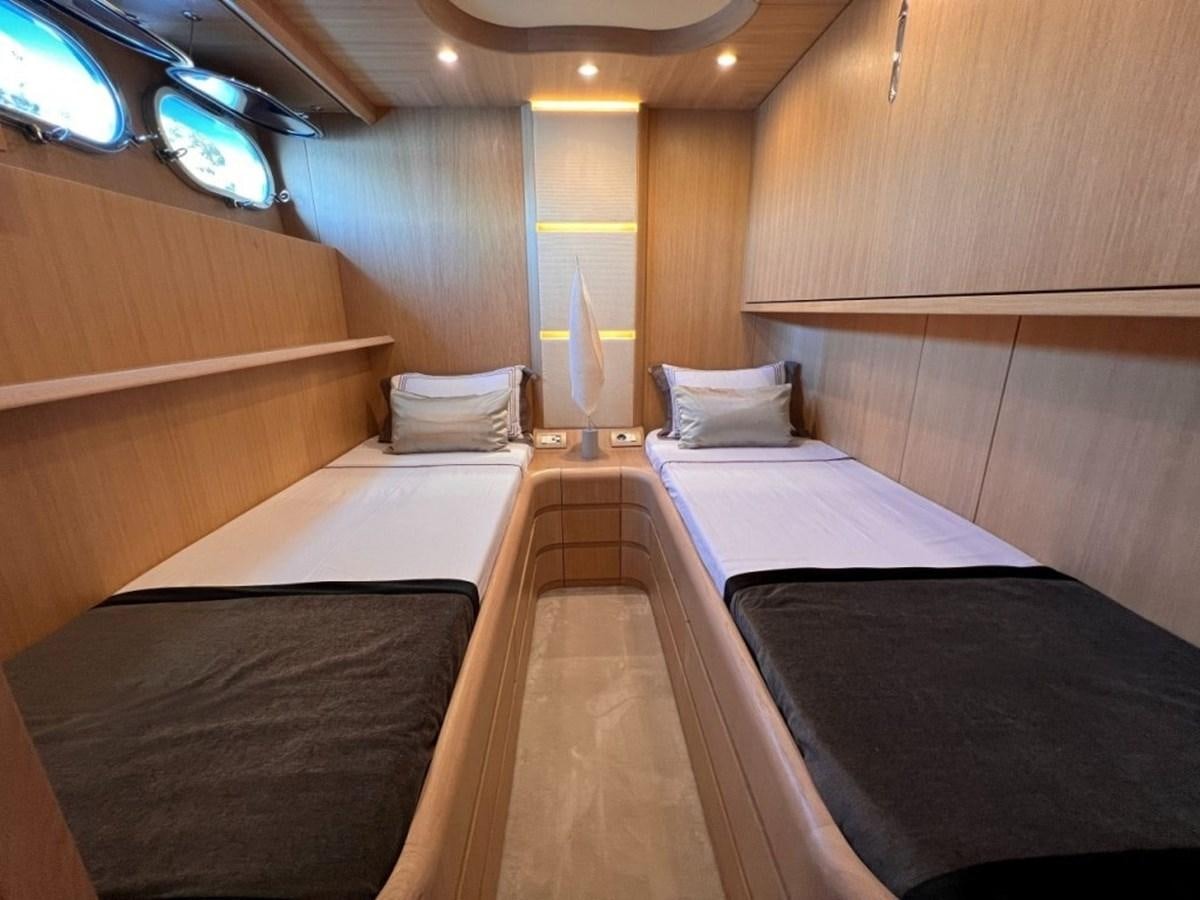 a room with beds and a window aboard MAIORA 26 Yacht for Sale