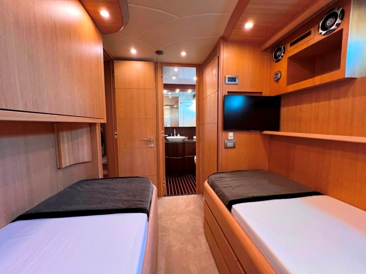 a room with a bed and a tv on the wall aboard MAIORA 26 Yacht for Sale