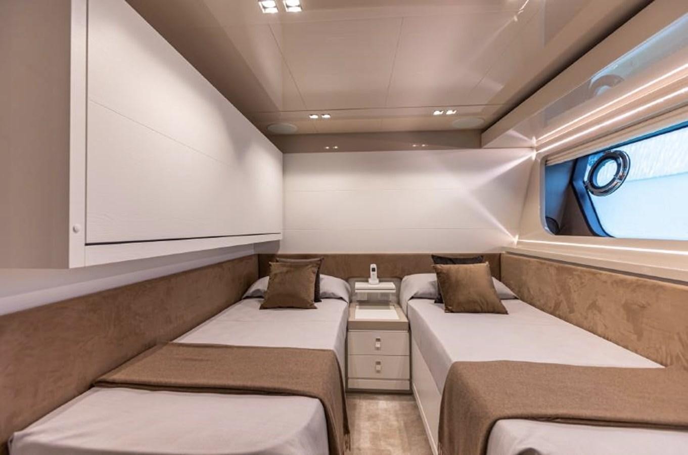a room with beds and a window aboard MIOTU 4 Yacht for Sale
