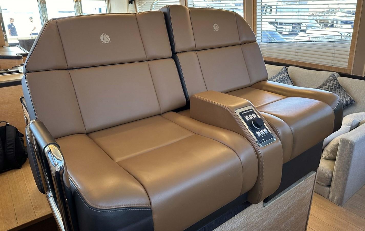 a leather couch with a phone on it aboard TYCHE Yacht for Sale
