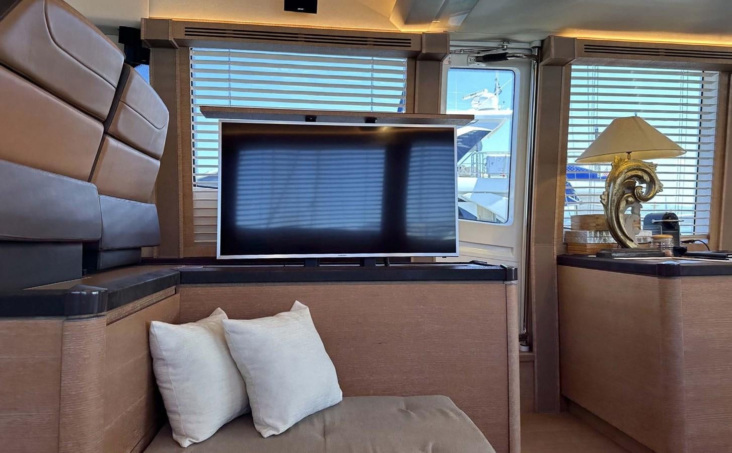 a room with a couch and a television aboard TYCHE Yacht for Sale
