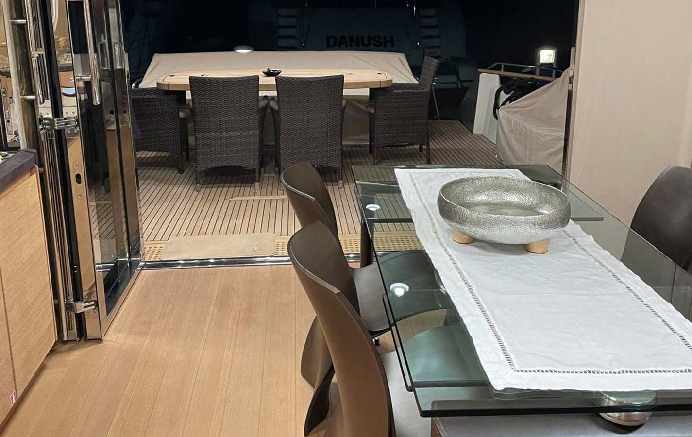 a table with chairs and a plate on it aboard TYCHE Yacht for Sale