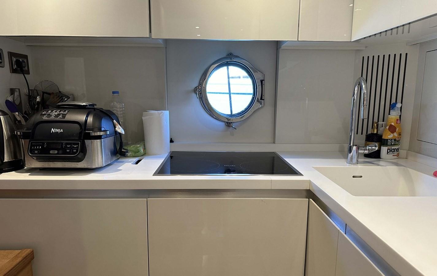 a kitchen with a sink and a microwave aboard TYCHE Yacht for Sale
