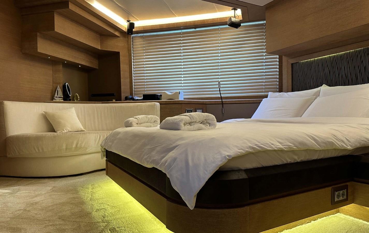 a room with a bed and a shelf with a window aboard TYCHE Yacht for Sale