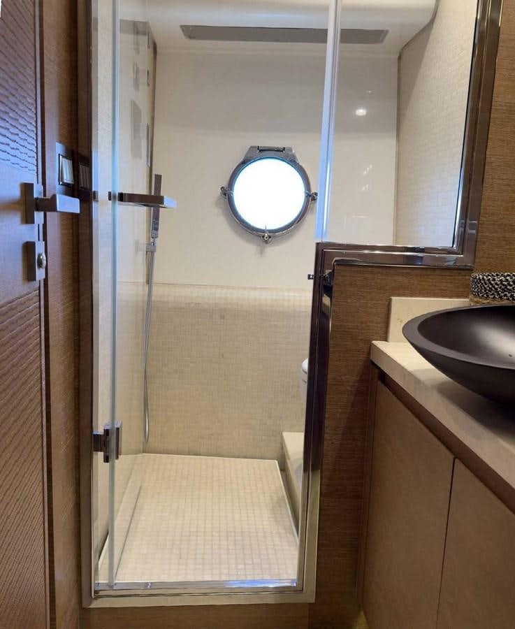 a bathroom with a glass shower door aboard TYCHE Yacht for Sale
