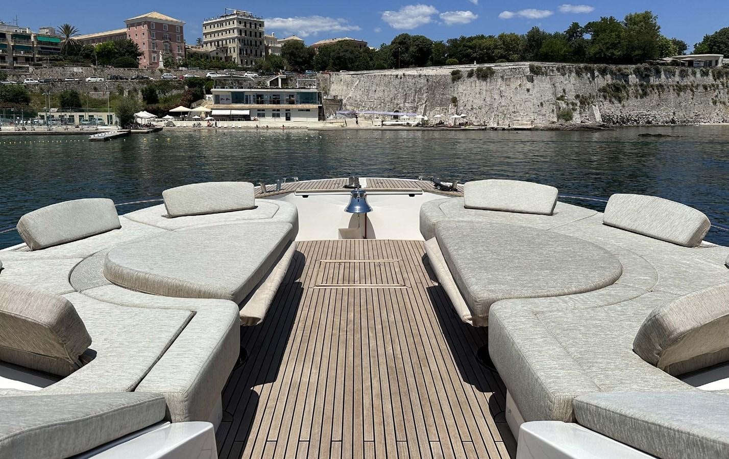 a deck with a view of a city and a body of water aboard TYCHE Yacht for Sale