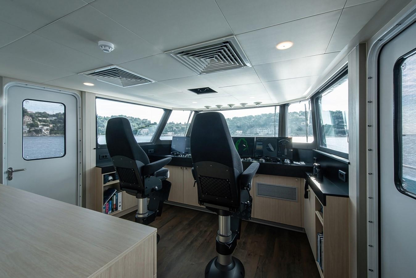 a room with a table and chairs aboard FIVE OCEANS Yacht for Sale