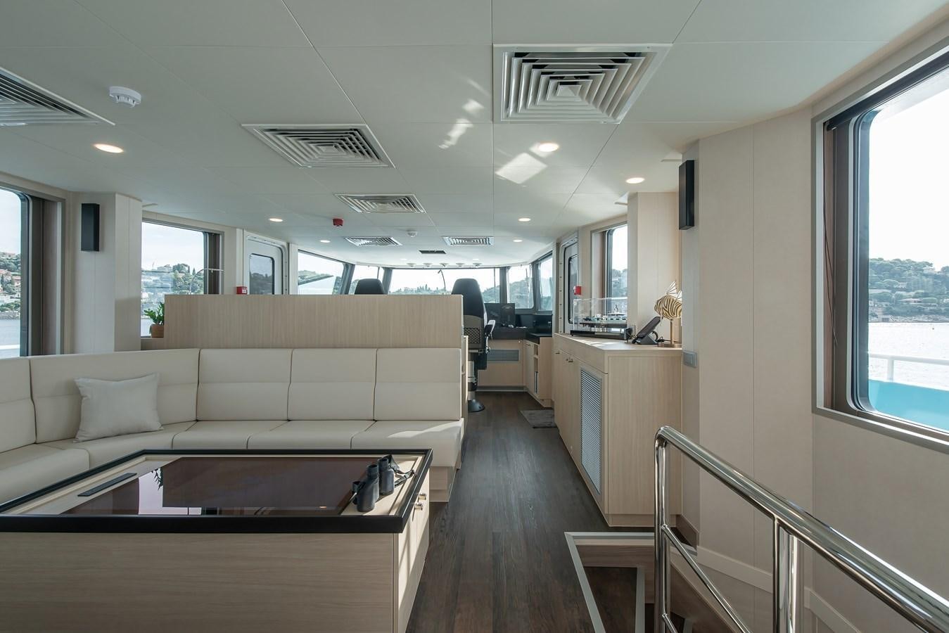 a living room with a couch and a table aboard FIVE OCEANS Yacht for Sale