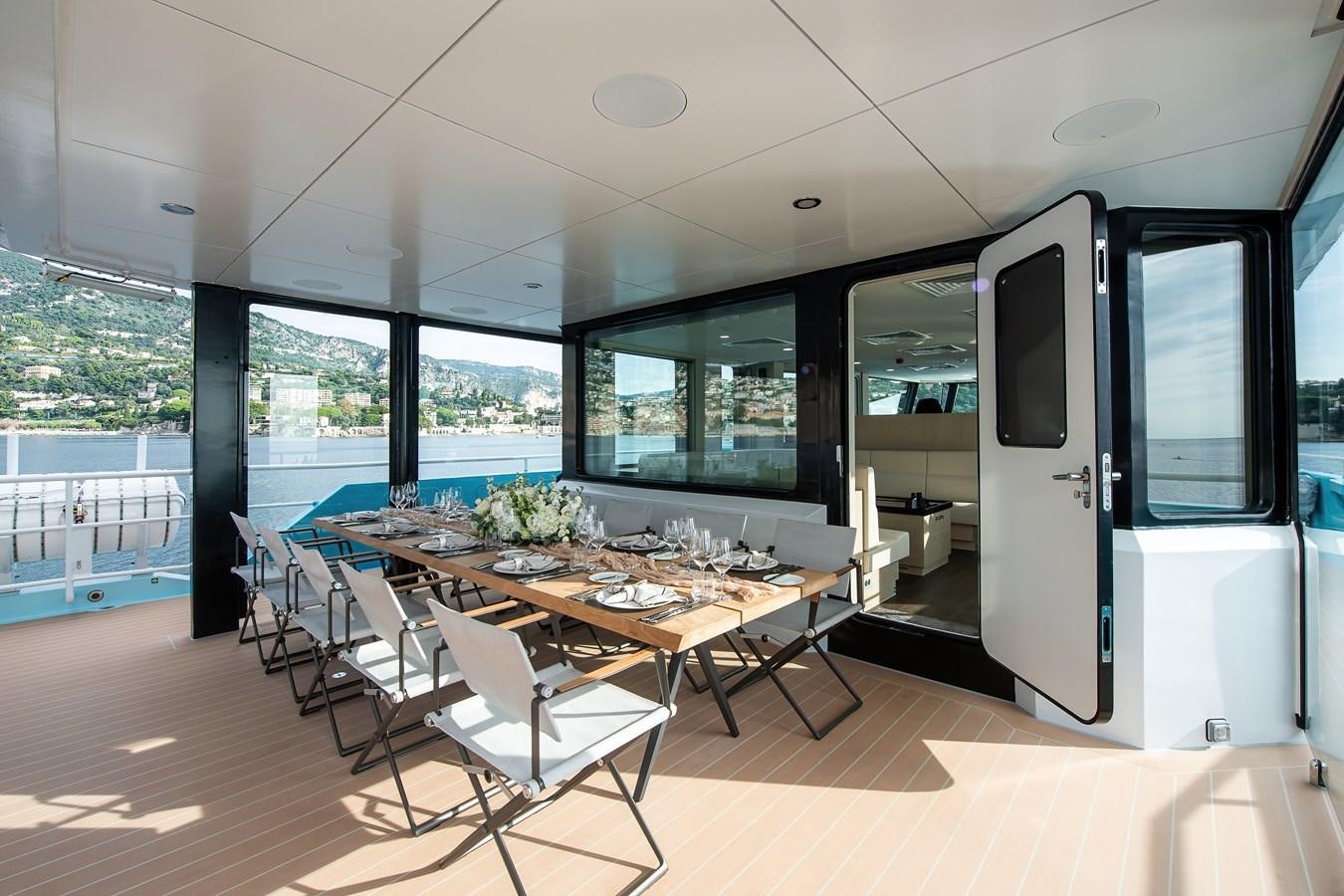 a room with a table and chairs aboard FIVE OCEANS Yacht for Sale