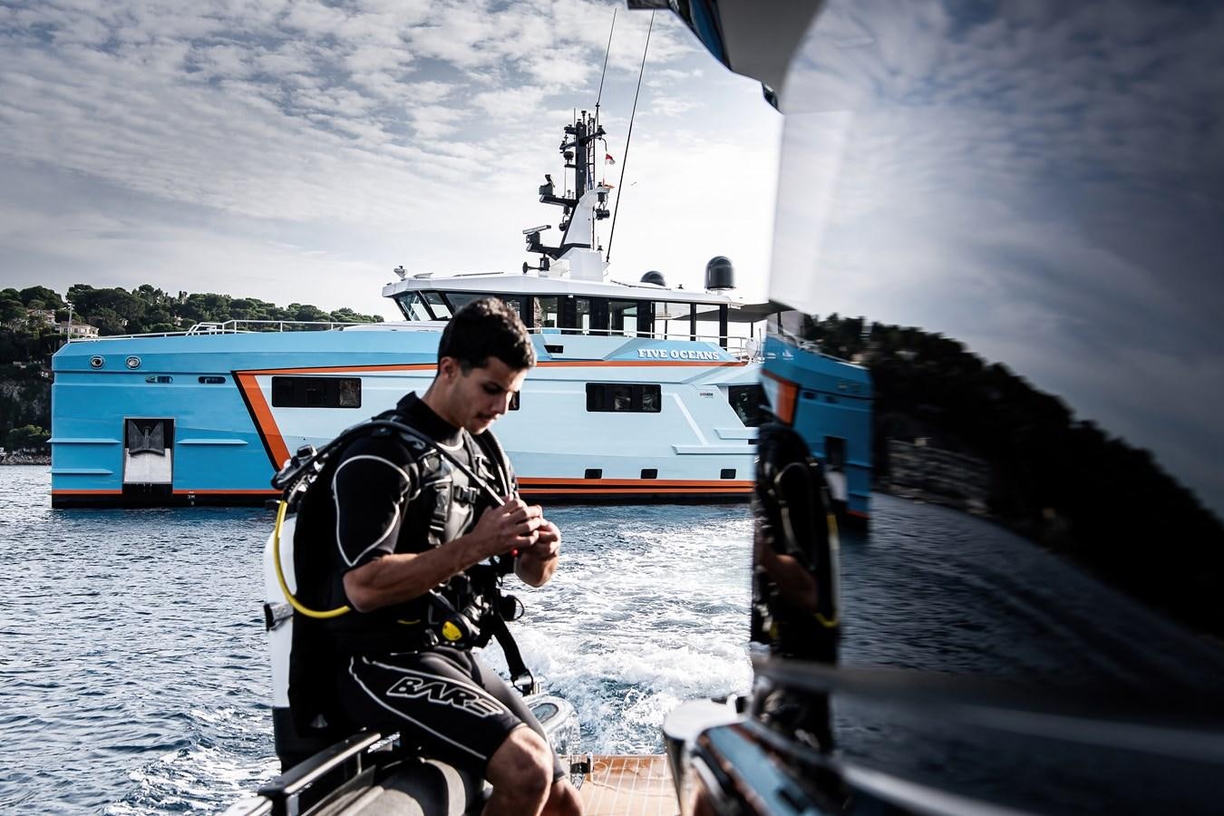 a man playing a guitar on a boat aboard FIVE OCEANS Yacht for Sale