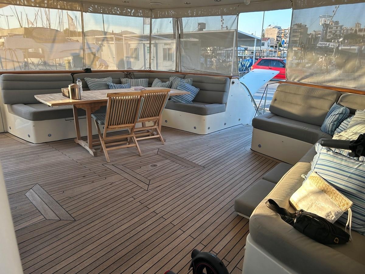 a room with a couch and a table and chairs aboard WHISPER Yacht for Sale