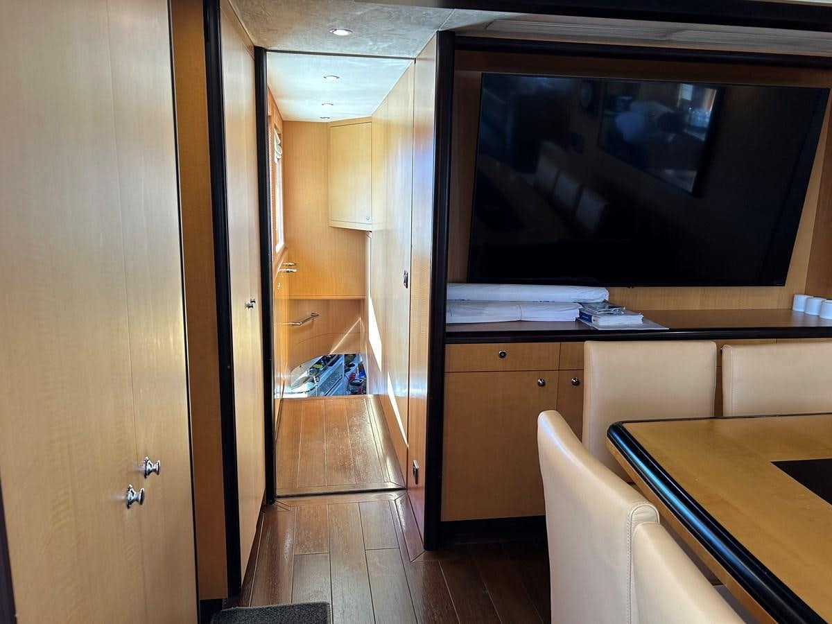 a room with a tv and a table aboard WHISPER Yacht for Sale