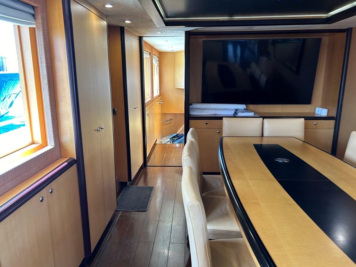 a room with a tv and a table aboard WHISPER Yacht for Sale