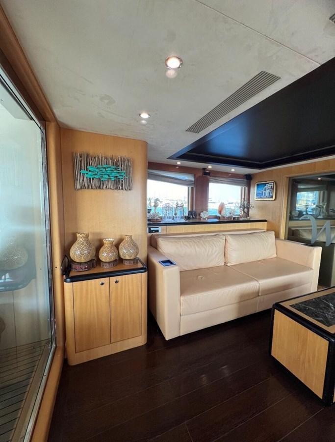 a living room with a couch and a kitchen aboard WHISPER Yacht for Sale