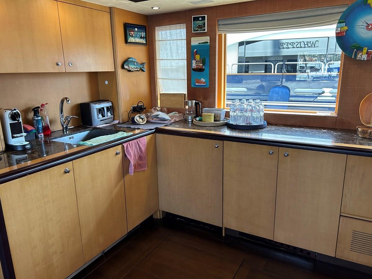 a kitchen with a large window aboard WHISPER Yacht for Sale