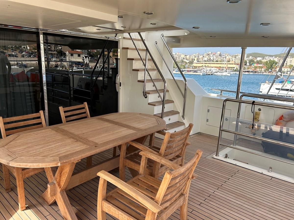 a table and chairs on a deck aboard WHISPER Yacht for Sale