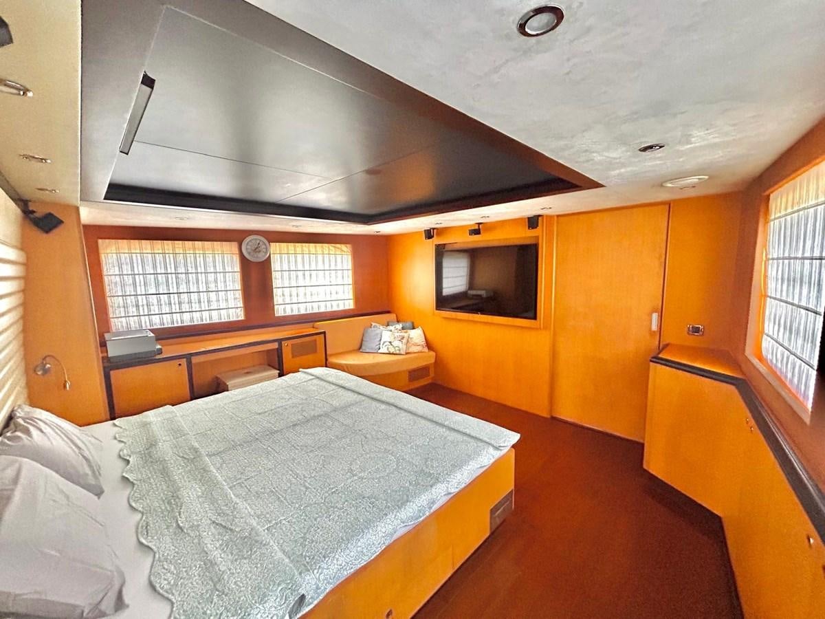 a bedroom with a bed and a tv aboard WHISPER Yacht for Sale