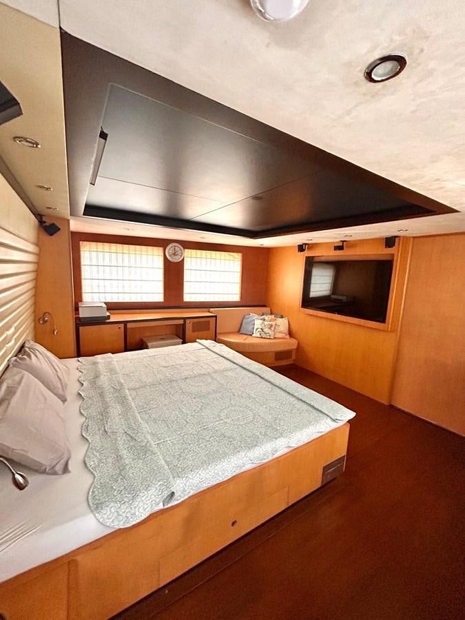 a bed with a round mirror above it aboard WHISPER Yacht for Sale
