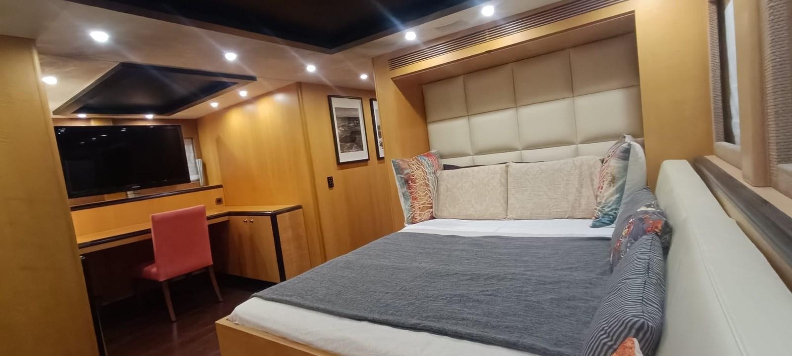a room with a bed and a chair aboard WHISPER Yacht for Sale