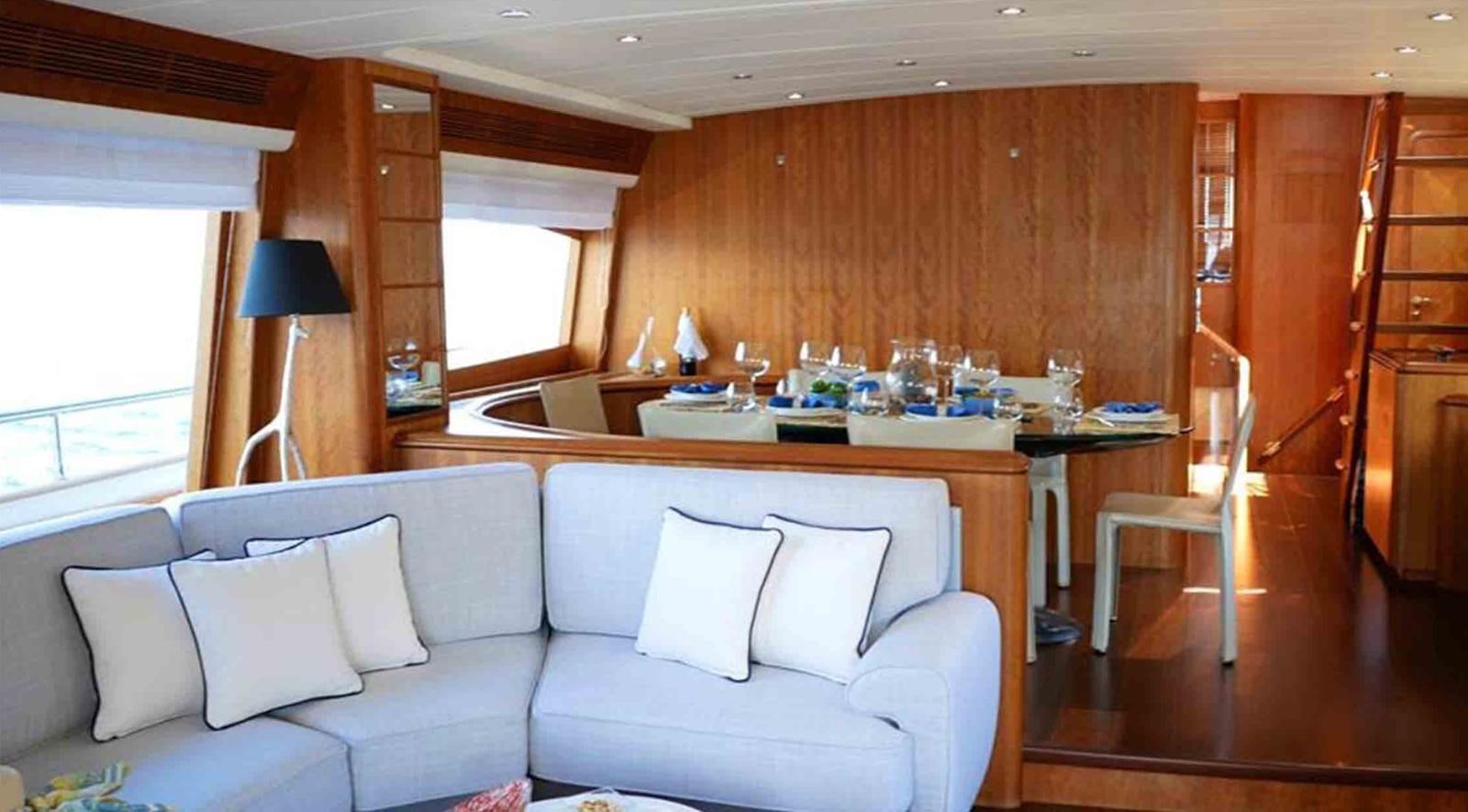 a living room with a couch and a table aboard COUACH 3000 FLY Yacht for Sale
