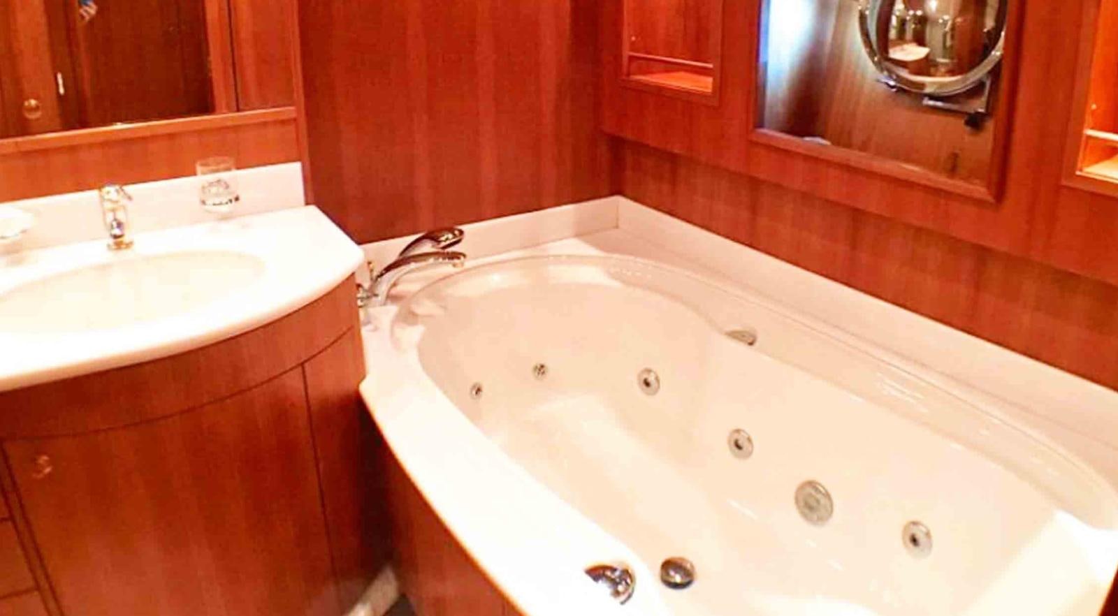 a bathroom with a sink and a mirror aboard COUACH 3000 FLY Yacht for Sale